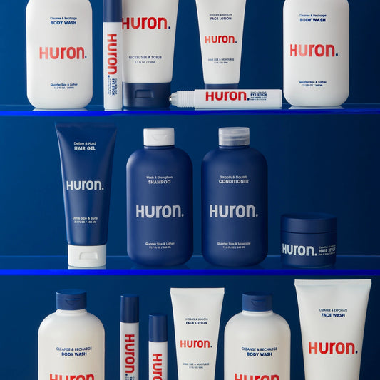 Skin care, hair care, and body care products sit on shelves against a dark blue wall. 
